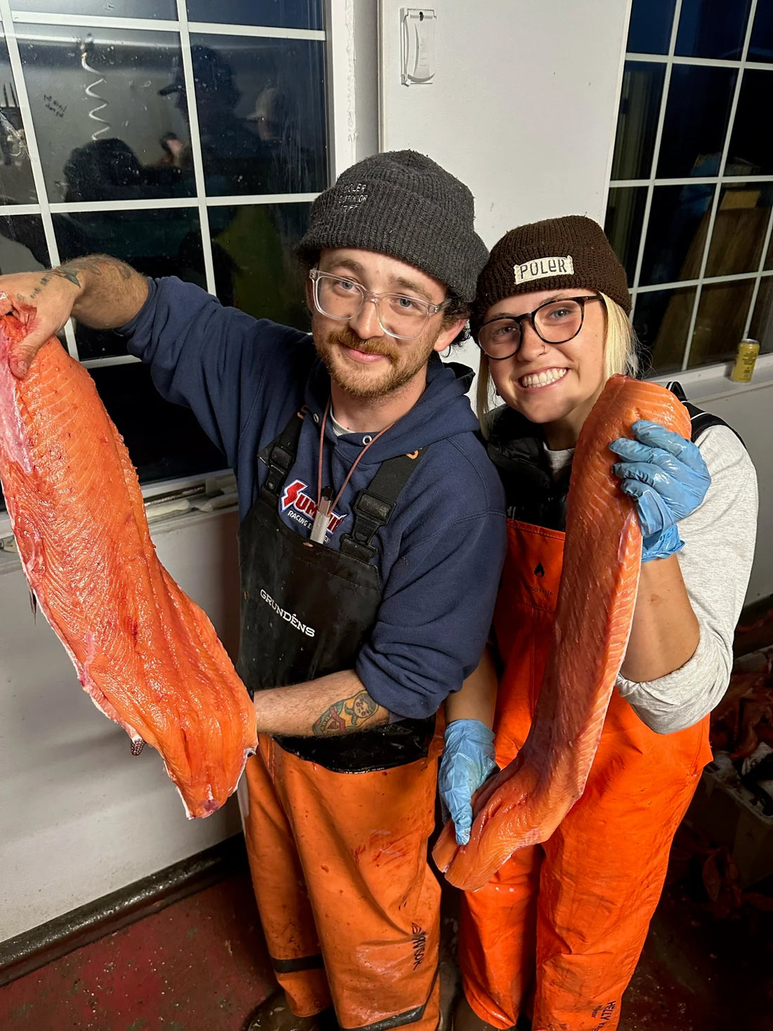 Crew holding processed salmon